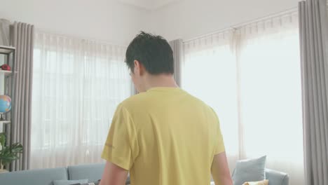 Back View Of Asian Man Training On Walking Treadmill At Home