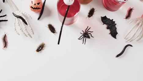 video of halloween drinks and decorations with copy space on white background