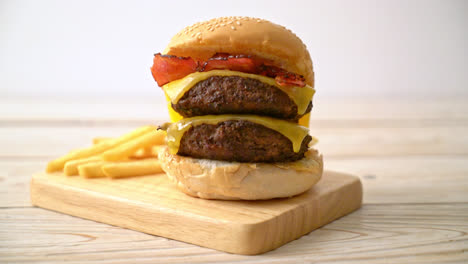 hamburger or beef burgers with cheese, bacon and french fries - unhealthy food style