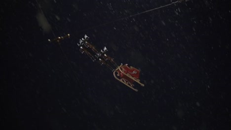 santa claus flying over a christmas market at a snowy night in germany