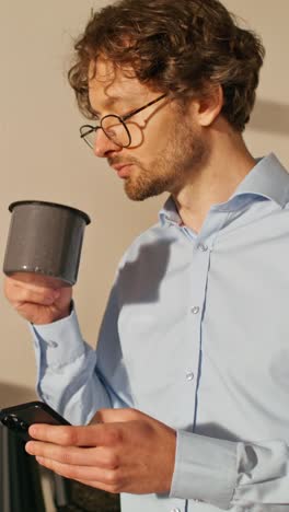 man working at office with coffee and smartphone