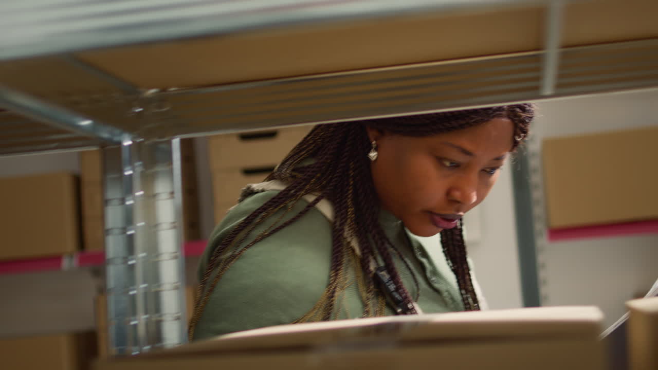 Woman in a warehouse checking boxes