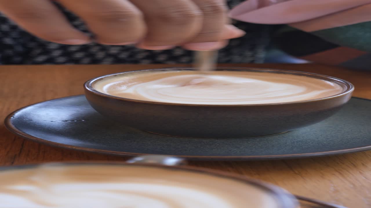 Person stirring latte art