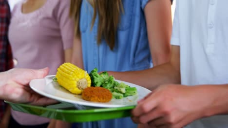 trabajador que sirve comida a los escolares 4k