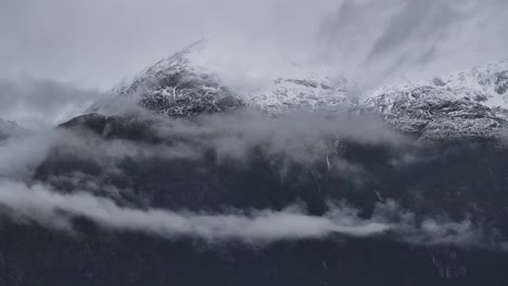 snow-capped mountains shrouded in mist and clouds