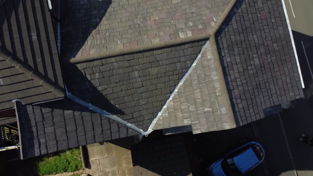 Rooftop inspection aerial view inspecting damage and repair of property real estate for homeowner