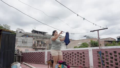 Adult-Hispanic-woman-on-the-terrace-of-her-house-in-a-poor-neighborhood-of-Tegucigalpa,-Honduras