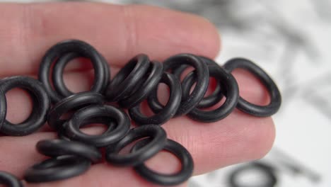 rubber sealing o-rings in hand for industrial and home plumbing use. round gaskets