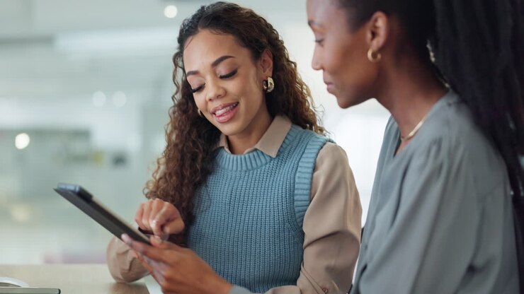 Business women, tablet and team talking creative