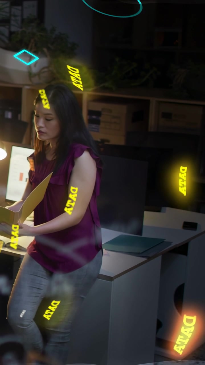 Vertical video: Woman holding yellow folder moving by desk checking laptop causing DATA orbs for IT