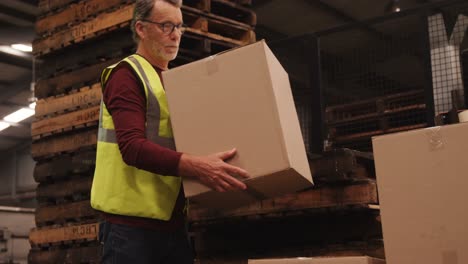 worker arranging box in warehouse