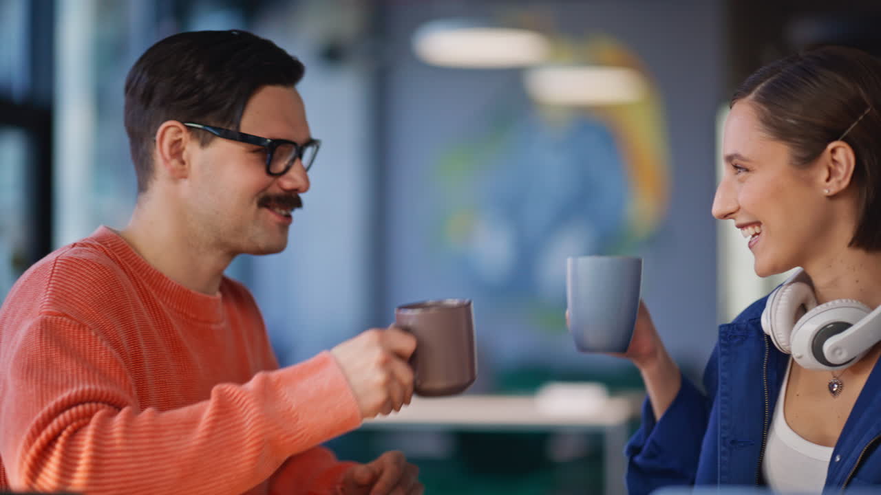 Friends have coffee break in cafe interior closeup. Smiling man woman toasting