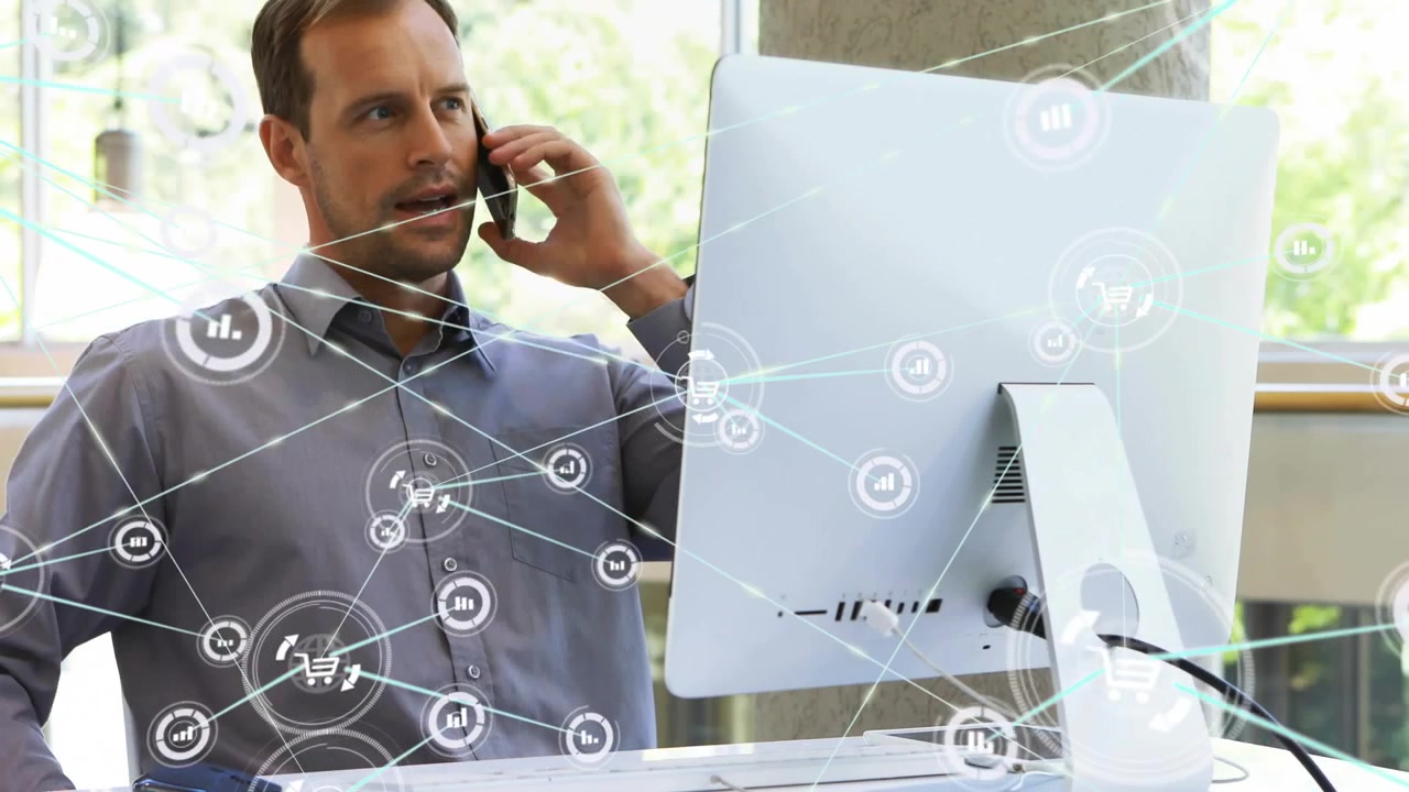 Male tech worker using PC while data rings appearing, causing leaning, taking phone and calling IT