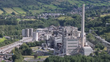 hope cement works aerial view across industrial factory chimney in idyllic derbyshire peak district