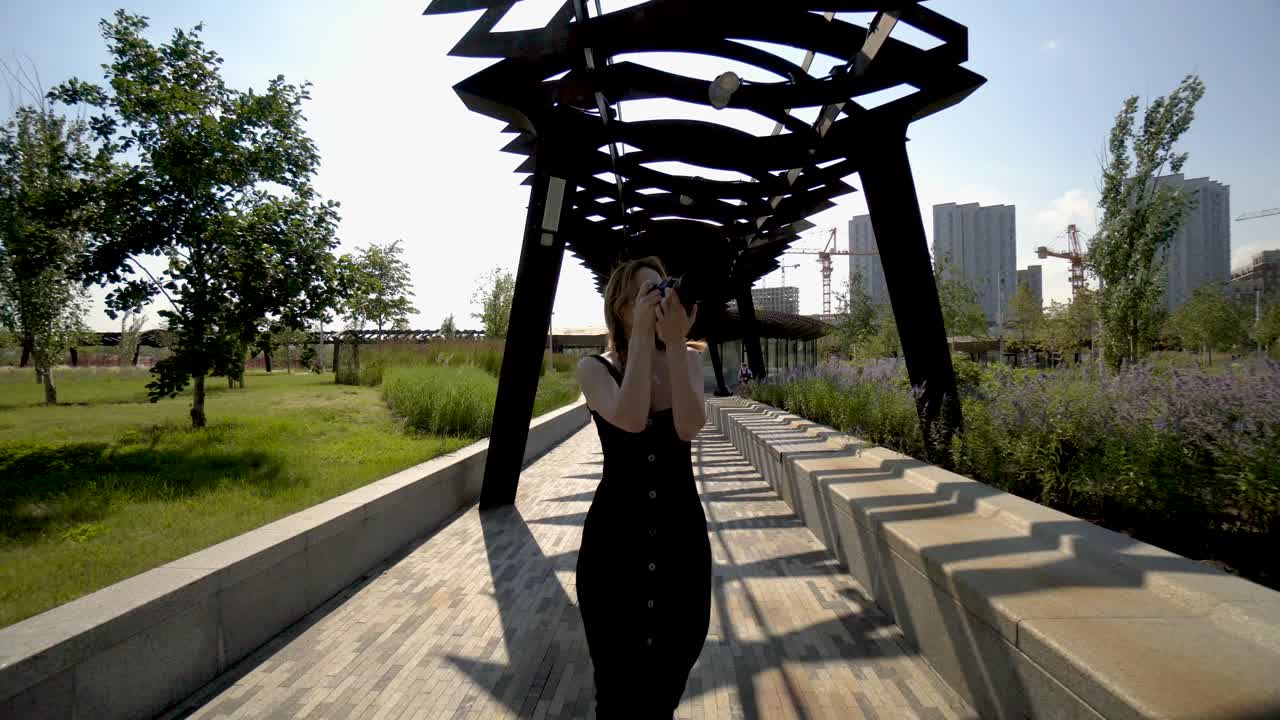 도시 공원에서 사진을 찍는 여자