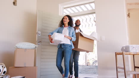 Slow-Motion-Shot-Of-Couple-Carrying-Boxes-Into-New-Home-On-Moving-Day