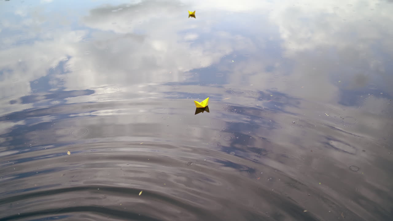 Paper boat sailing along river. Small paper boat is flowing along river