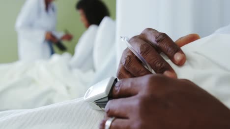 Close-up-of-pulse-oximetry-on-African-american-male-patient-hand-in-the-ward-at-hospital