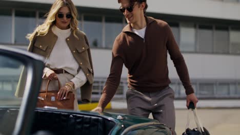 couple near a classic car