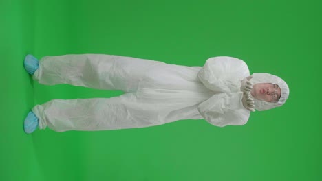 full body of male wearing personal protective equipment uniform ppe blowing kisses to a camera in the green screen studio