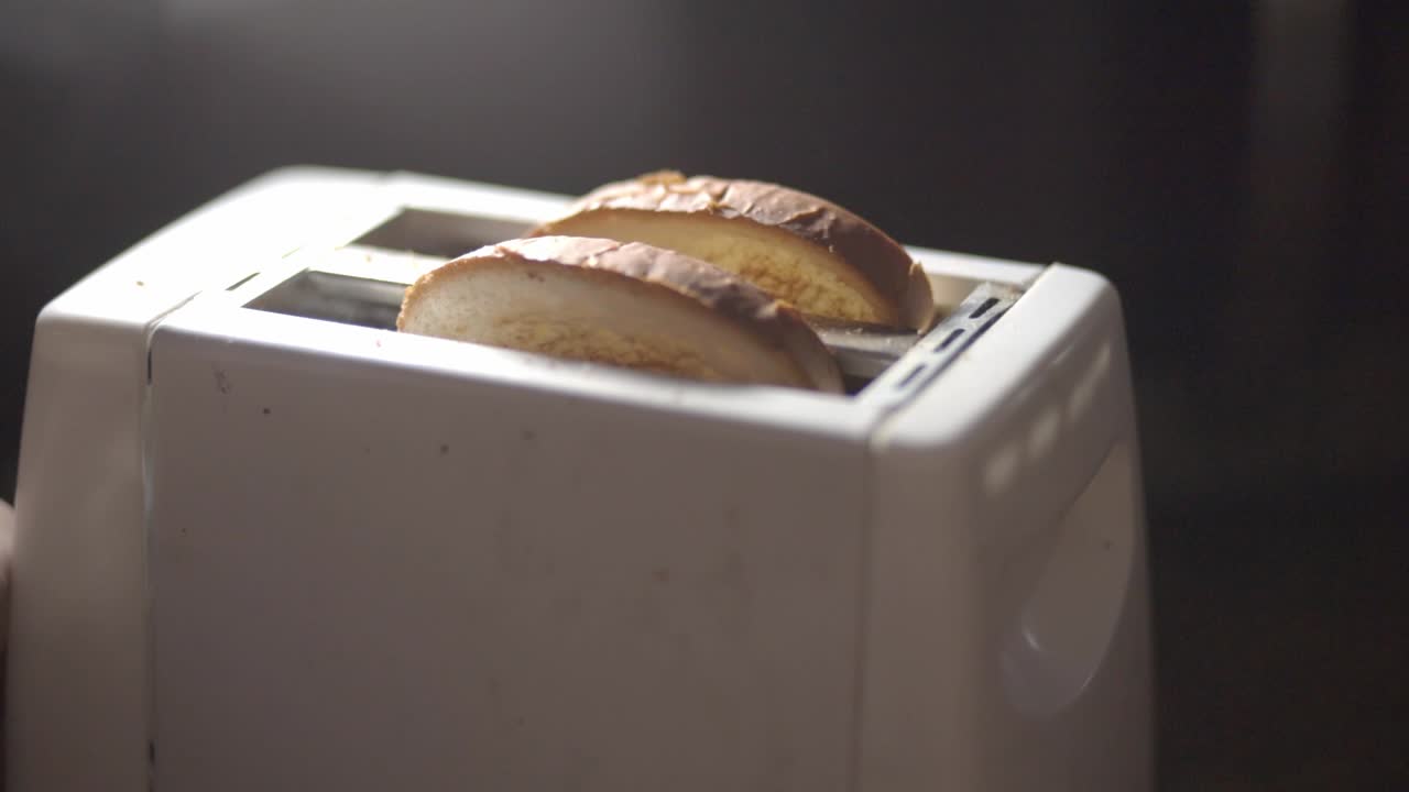 Two Slices Of Wheat Bread Popping Out From A White Toaster