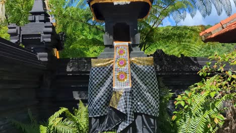 Sanggah Balinese shrine adorned with traditional Balinese offerings and decoration on tropical island of Bali Indonesia
