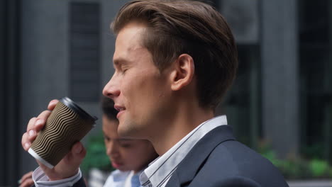 portrait smiling businessman drinking coffee commuting to office morning routine