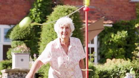 Active-Senior-Woman-Playing-Game-With-Bat-And-Ball-In-Garden