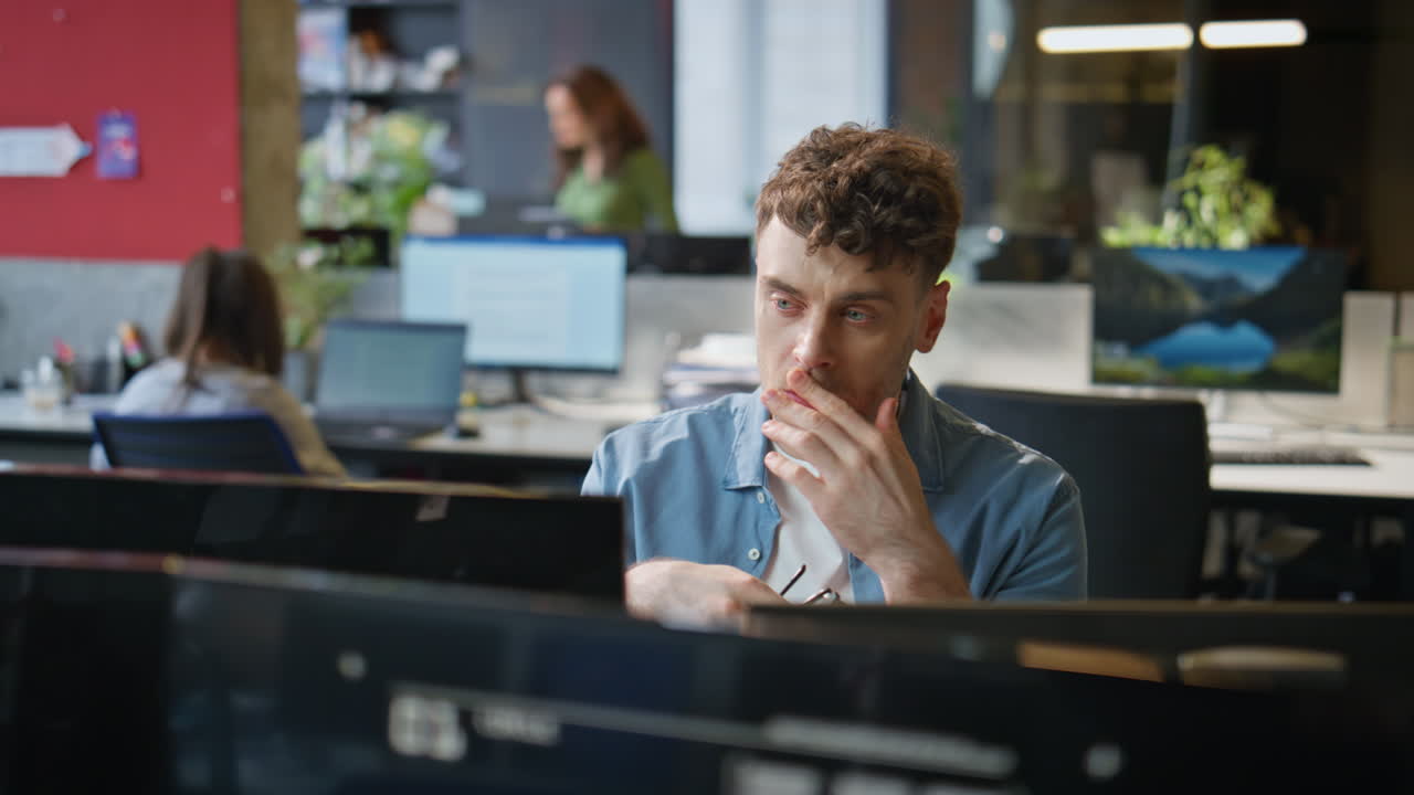 Overworked manager staring desktop working open space closeup. Tired freelancer