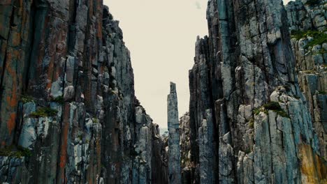 cape hauy drone flying past single dolerite in tasmania, australia