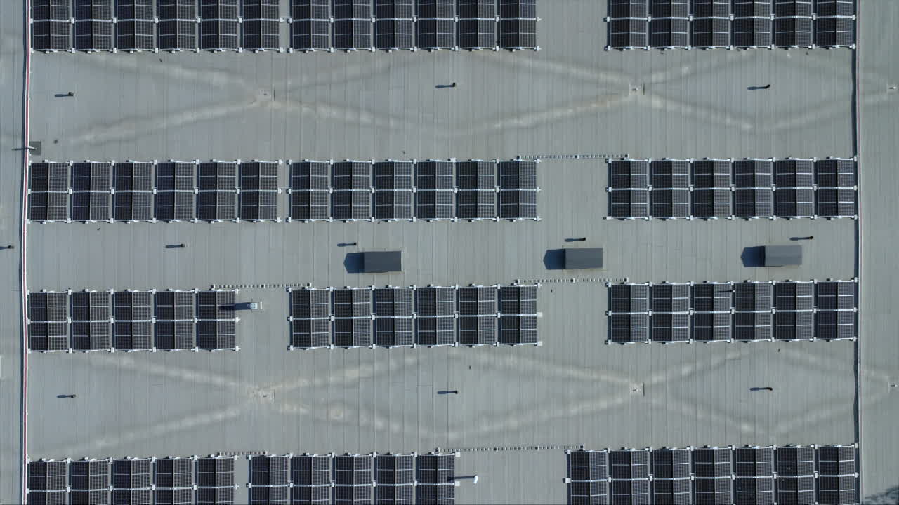 Aerial looks directly down onto solar panels installed on building roof