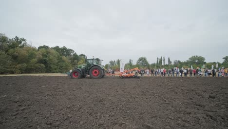 demonstration of agricultural machinery at an exhibition. tractors operate in the field, showcasing their capabilities and performance in action