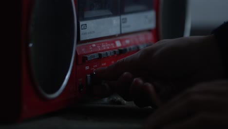 Close-up-of-male-hand-turning-on-vintage-radio-and-adjusting-volume