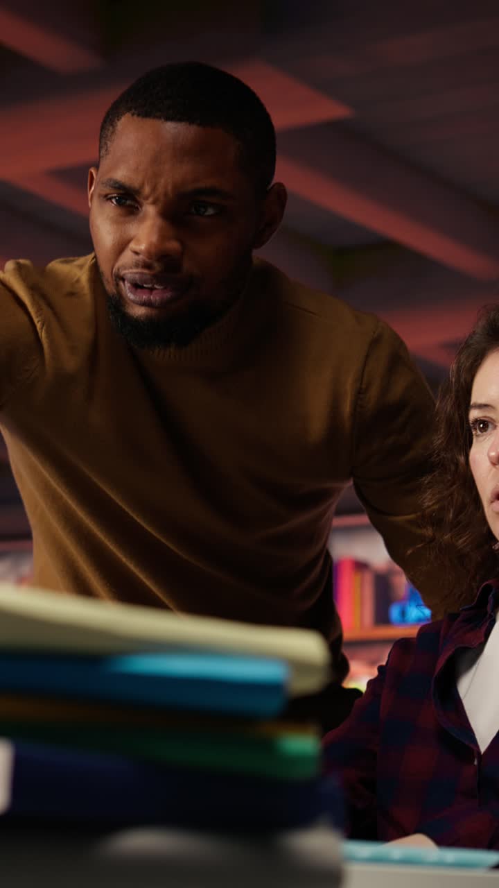 Vertical video Startup office chief technology officer overseeing woman building application