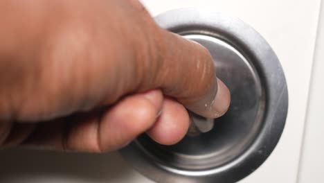 Hand turning a door handle