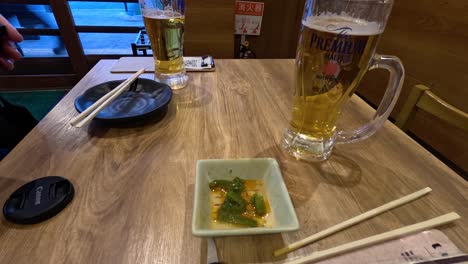 people enjoying beer and snacks at a table