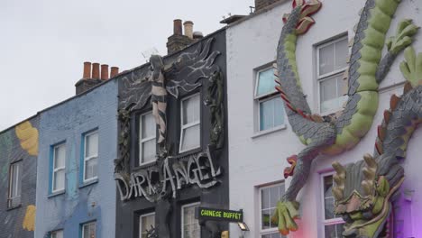 Painted-And-Sculpted-Advertising-Displays-On-Outside-Of-Store-Buildings-In-Camden-North-London-UK-3