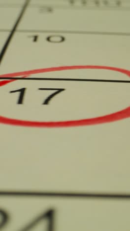 close-up of a calendar with a red marker