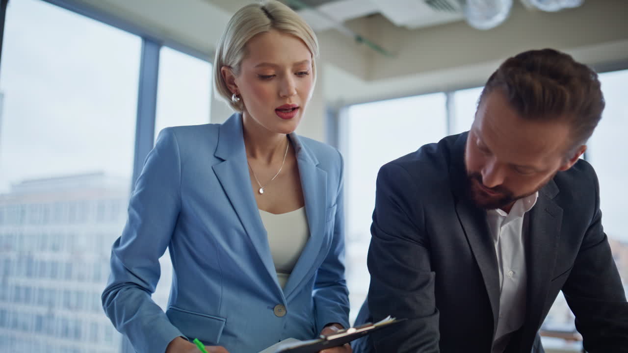 Closeup business team analyzing documents together at office. Worried colleagues