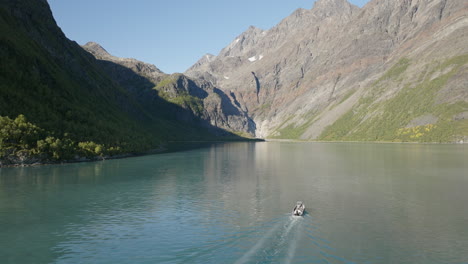 Sightseeing-on-board-of-cruiser-boat-in-Lyngen-fjord-with-Scandinavian-Alps-in-background,-Norway