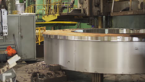 metal disk being machined in a factory setting.
