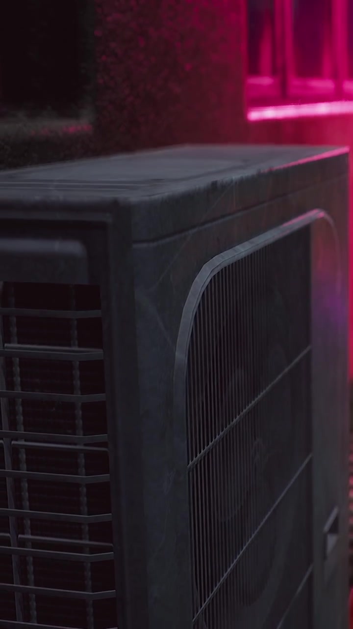 Fan runs in a room with colorful lighting and shadows during evening time
