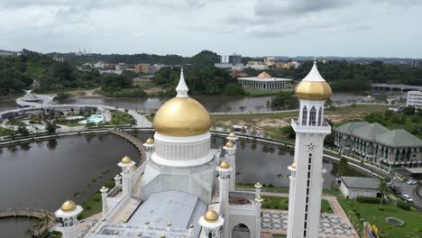 aerial drone shot of golden minarets and dome on the sultan omar ali saifuddien mosque in bandar seri bagawan in brunei darussalam