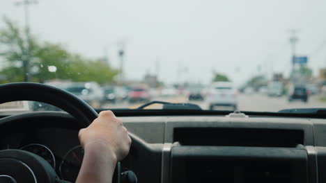 Hands-Of-The-Driver-On-The-Steering-Wheel-Riding-In-Traffic-Jams