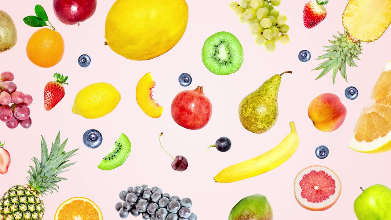 Creative 4k stop motion video animation of many different exotic tropical bright fruits that quickly appear on a soft pink color background and disappear. View from above. Seamless loop.
