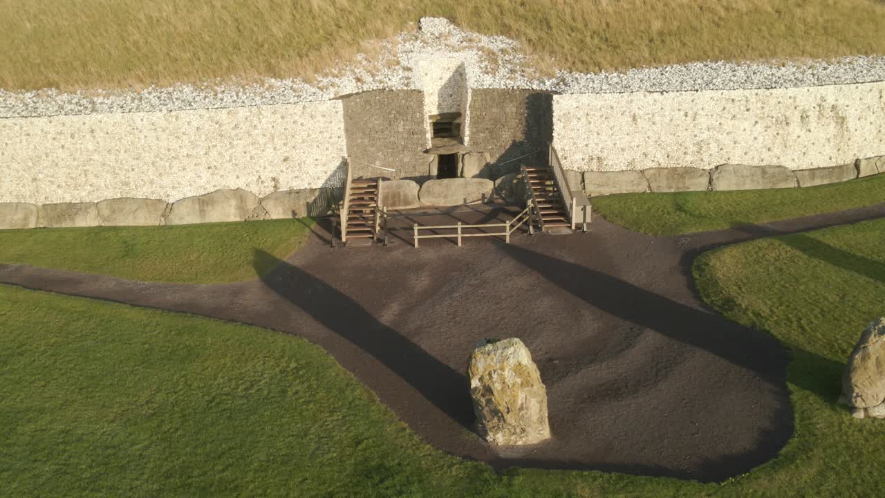 Upright Stones in Front Of Newgrange Entrance At Sunrise In County Meath, Ireland. - aerial shot