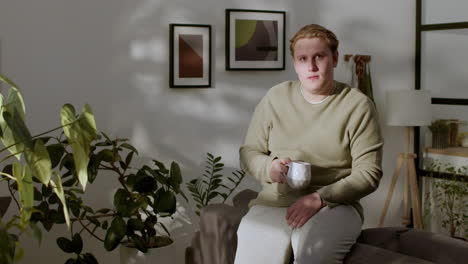 man drinking coffee at home