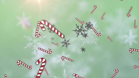 Multiple-candy-cane-icons-falling-against-snowflakes-and-spot-of-light-against-green-background