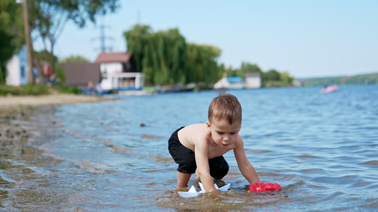 Child Playing with Paper Boats in Water
