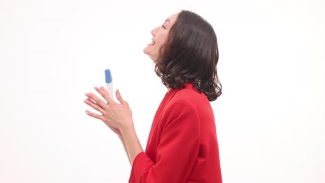 excited woman reacts to positive pregnancy test
